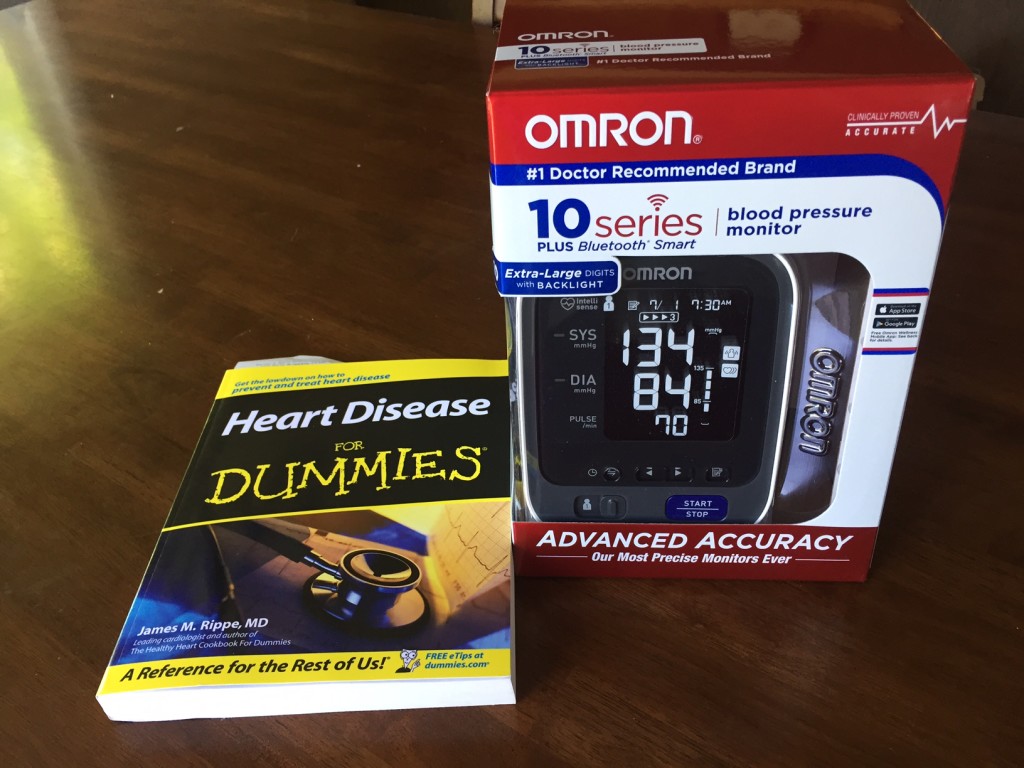 A photo of a blood pressure monitor and the book "Heart Disease for Dummies"